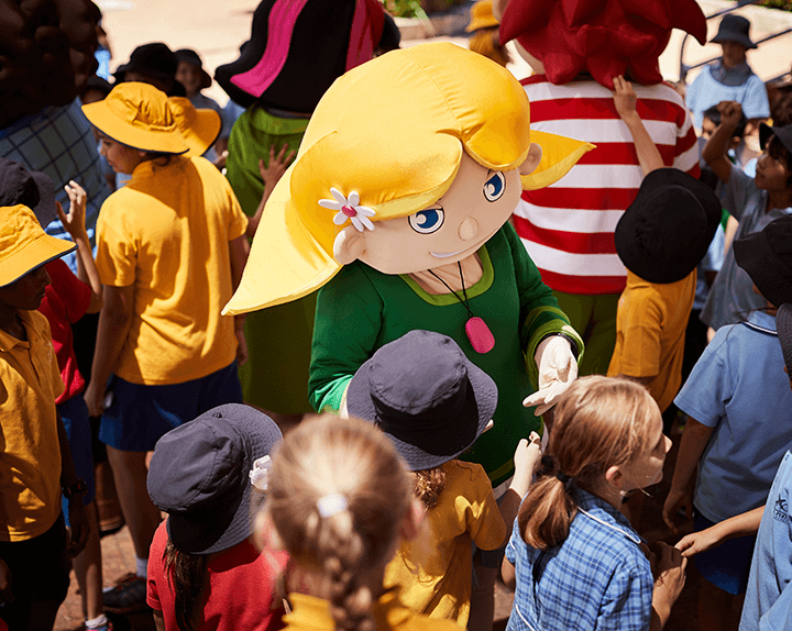 Crowd of school children surrounding an RAC mascot