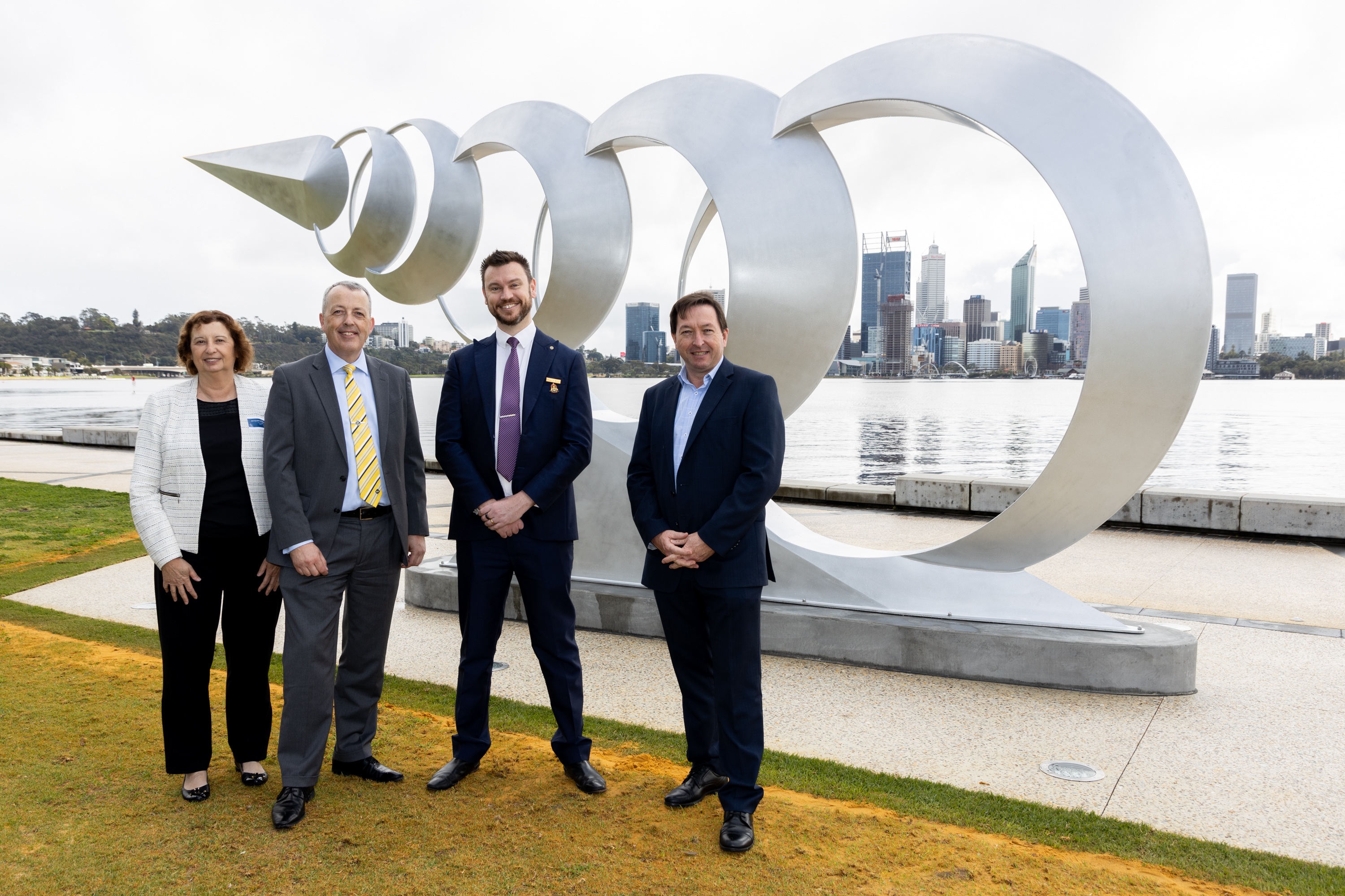 RAC President Jacqueline Ronchi, RAC Group Executive Robert Slocombe, City of South Perth Mayor Greg Milner and City of South Perth CEO Mike Bradford standing in front of the R/evolve sculpture on the South Perth foreshore