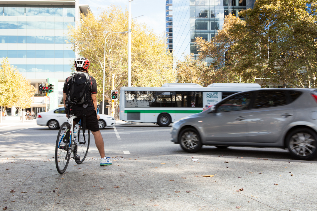 A cyclist waiting at the lights