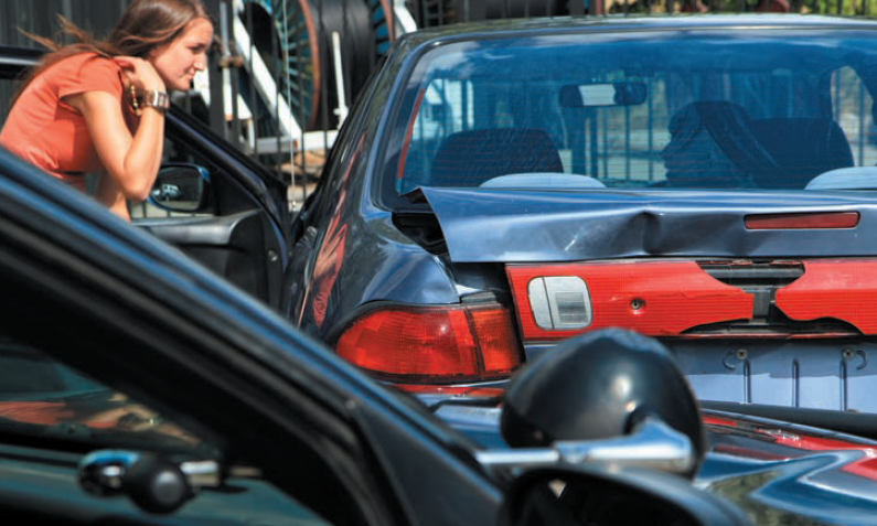 Lady assessing a rear end crash