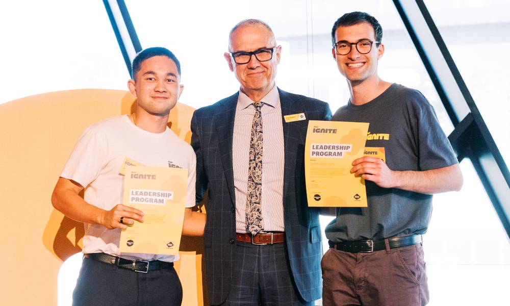 Matthew Menezes and James Della Gatta holding certificates with their certificates