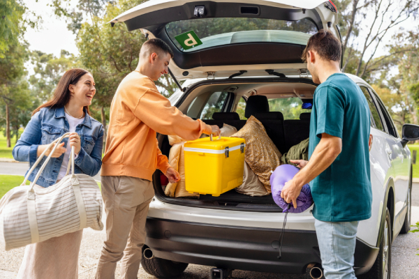 Young people packing their car for a road trip