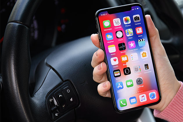 Holding an iPhone X in the car