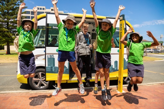 Kids jumping in front of Intellibus