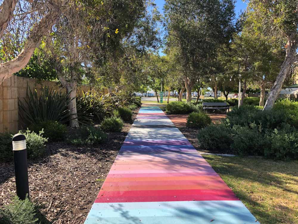 A footpath in Mandurah painted in a variety of coloured stripes