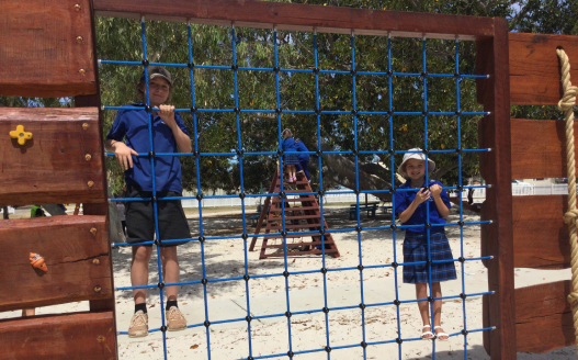 Two kids climbing on playground