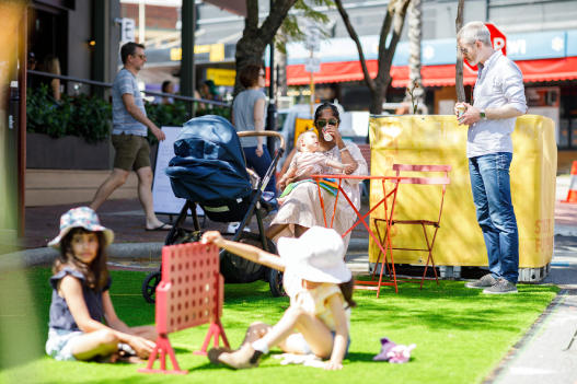 Parents and children sitting in pedestrian plaza