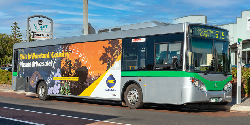 A bus covered with the artwork 'Season's Journey' by Wardandi Yamatji Wongi artist Tahneqa Dann. Over the artwork is text that states "This is Wardandi Country. Please drive safely".