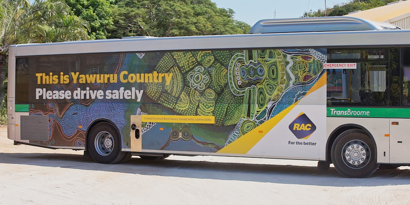 A bus covered in the artwork 'Goorlil' by Bard-Yawuru artist Leanne Dolby. Over the artwork is text that states "This is Yawuru Country. Please drive safely". 