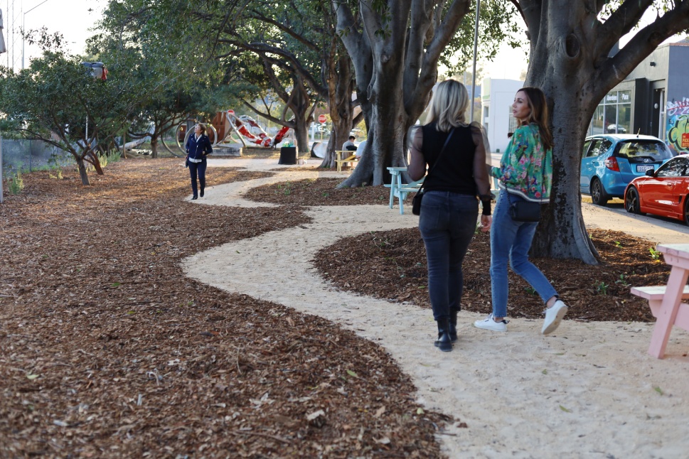 Two people walking in park