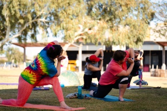 People doing yoga in the park