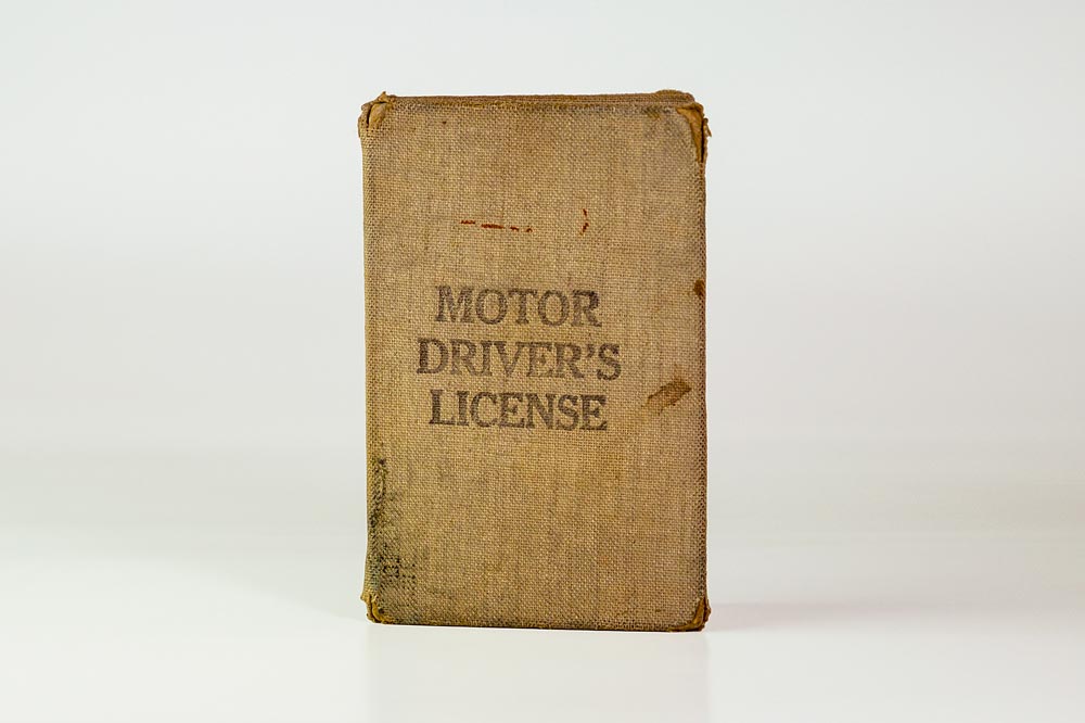 The front of the Motor Driver's License - an old canvas booklet with the title branded into the fabric.