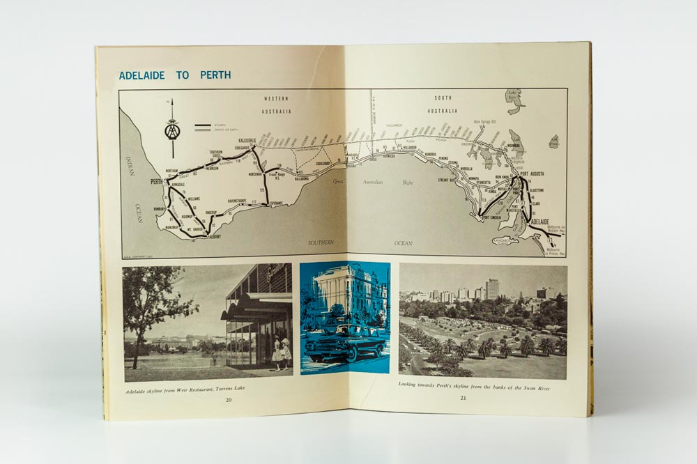 Pages 20 and 21 of the Eyre Highway Guide - A map showing the routes from Adelaide, South Australia, to Perth, Western Australia. Underneath are three images. Image one: Adelaide's skyline from Weir Restaurant, Torrens Lake. Image two: A blue, black and white woodblock print of a classic car parked on the street in front of a building. Image three: Perth's skyline as seen from the banks of the Swan River.