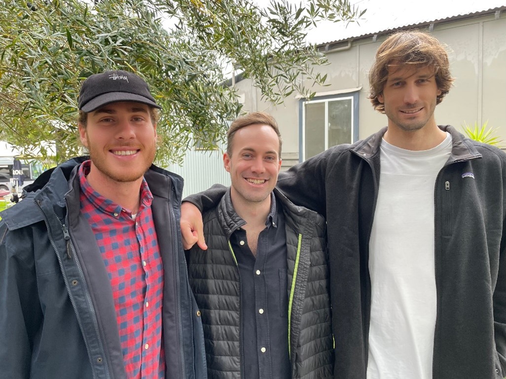 Jack standing between two mates who he surfs with