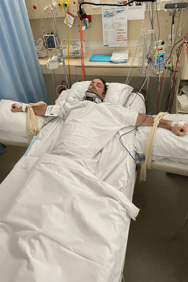 Jack laying in a hospital bed during his recovery from the surfing incident