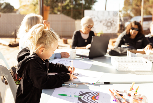 Child colouring at activity table