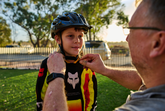 Child putting on a helmet