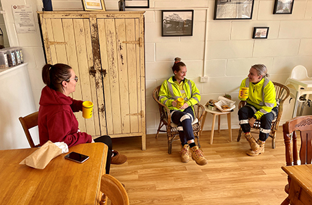 Three people enjoy a coffee together in a cafe'