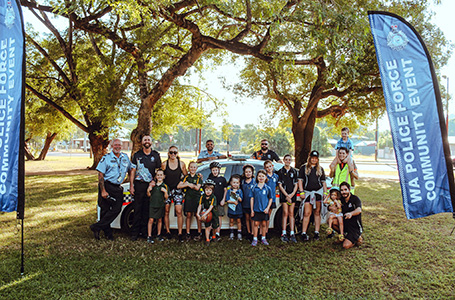 A group of volunteers pose together in a park