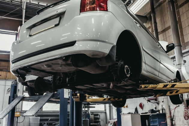 A car being serviced on a lift