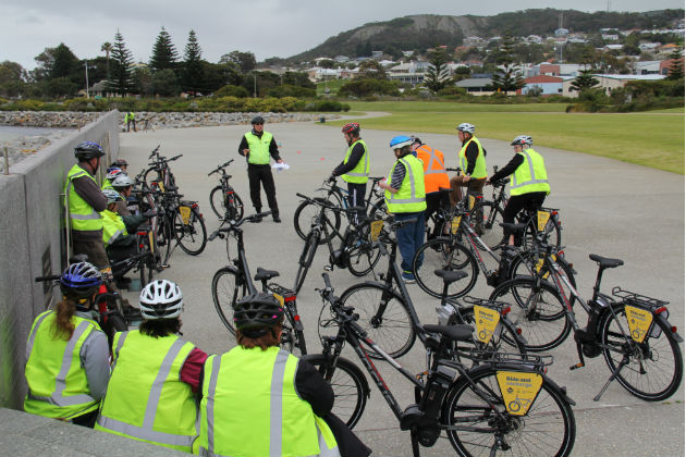  A group of new ebike users listening to an instructor
