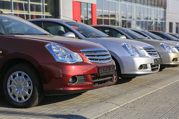  A row of new cars at a car dealership