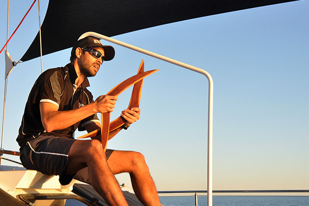 Bart Pigram showing guests boomerangs on his new eco cruise of Broome's Roebuck Bay