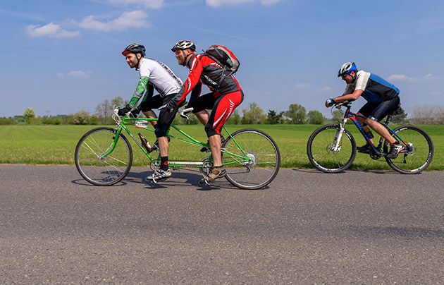 Tandem bike riders on the road
