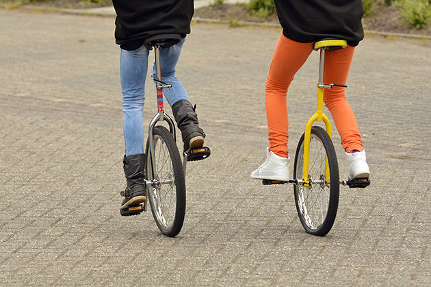 Two unicycles and riders