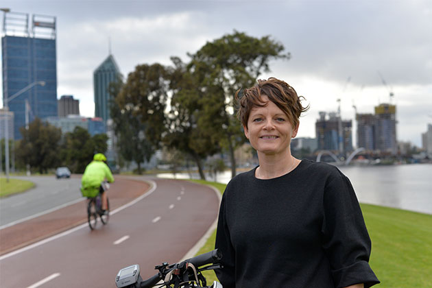 Sarah Court with a cyclist whizzing past on a bike path in the background