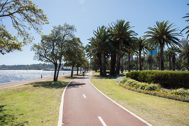 A cyclist riding on the bike path along Riverside Drive