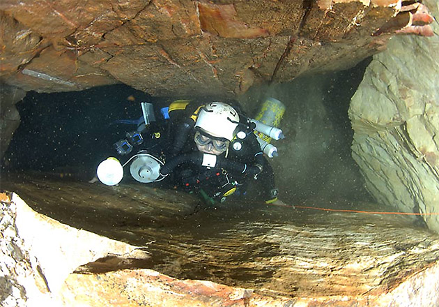 Squeezing through a narrow passage at Kija cave in the Kimberley