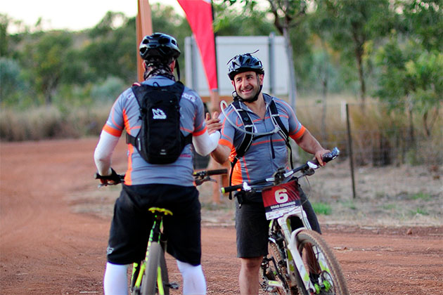  Two team mates shaking hands after a day of riding on the Gibb River challenge