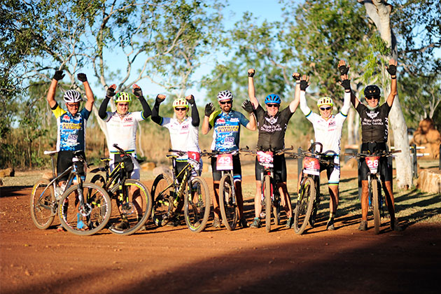 A group of riders celebrating on the Gibb River Road