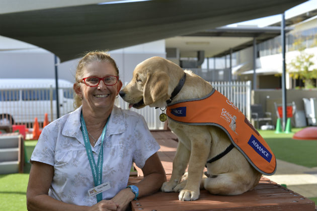 Leanne Rogers with her affectionate foster puppy Shane