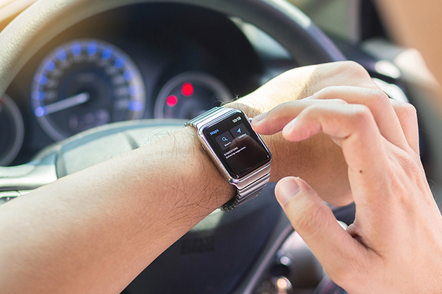Image of person using smartwatch in car