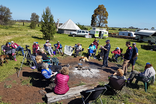 A group of elderly campers listen to their tour guide