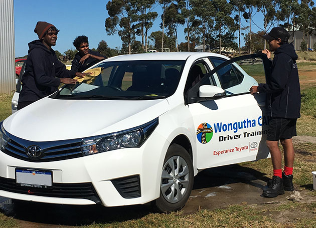 Wongutha CAPS school students clean a driving program car