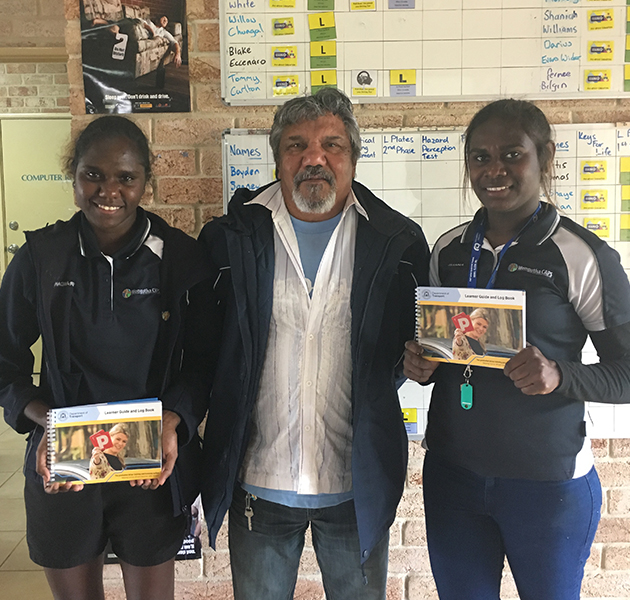 Wongutha CAPS students Zarelda Dickens and Zianna Gordon with driving instructor Mr Harry Graham
