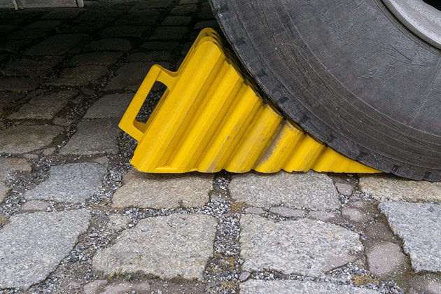 Wheel chocks under a car tyre