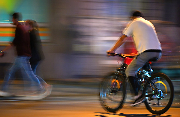 Man riding a bike at night