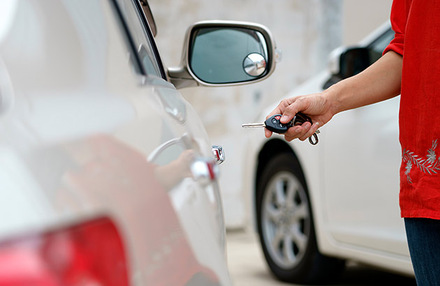 Woman locking her car door