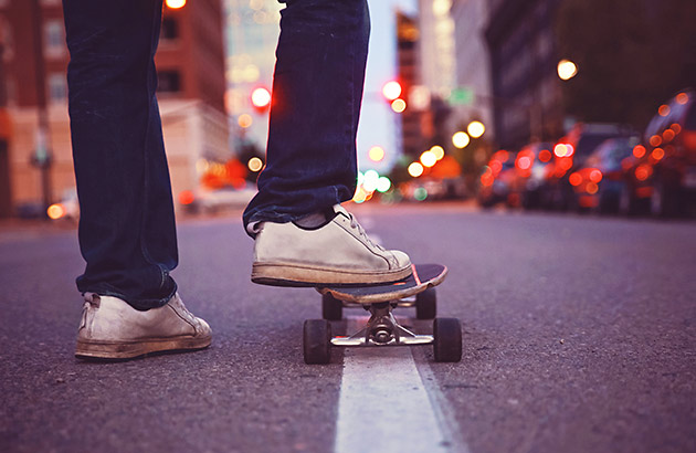 Skateboard rider on a city road