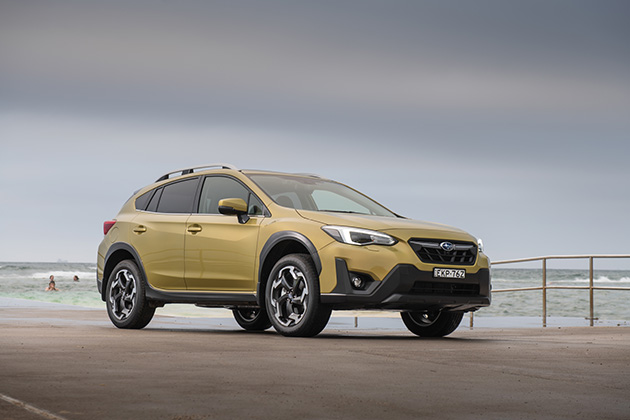 Yellow Subaru car parked near the beach