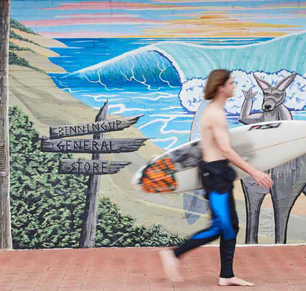 Person walking with a surfboard