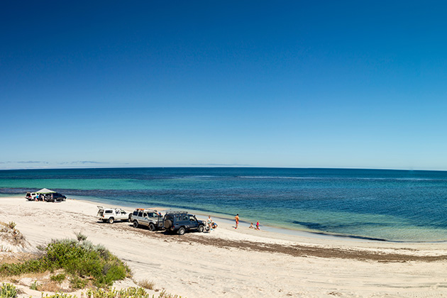 4WDs on a long stretch of beach