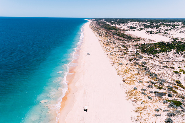 4WD on a long stretch of beach