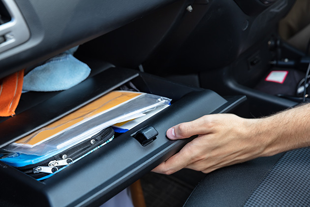 Person checking a car's glovebox