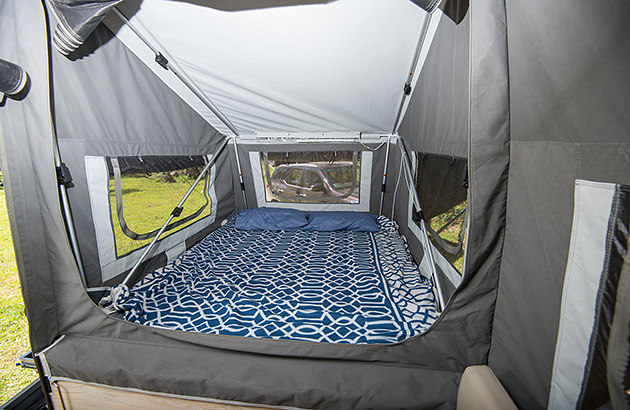 A bed in a camper trailer