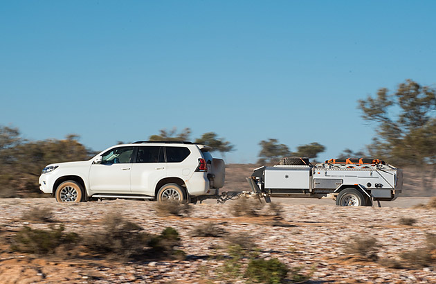 A hard-floor camper trailer being towed